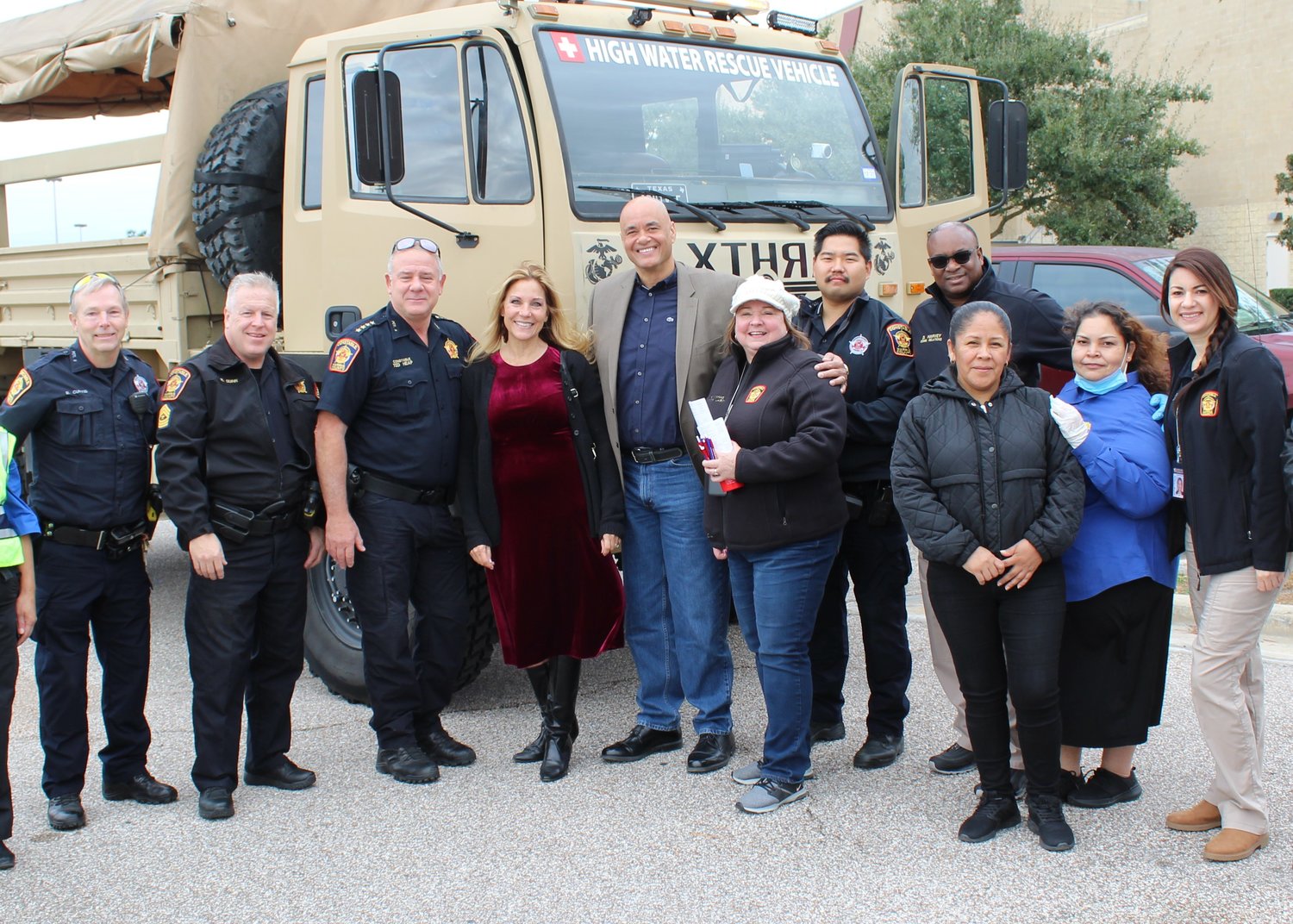 Harris County Pct. 5 Constable Ted Heap, third from left, Rosemary Jackson, fourth from left, and Aaron Jackson pose with others in front of a rescue truck the Jacksons purchased—but hope never to use—for hurricane victim rescue operations.